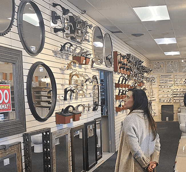 Woman shopping for bathroom fixtures at a home improvement store.