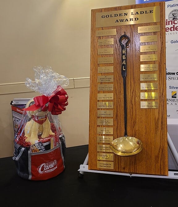 Golden Ladle Award plaque next to Raising Cane's gift basket.