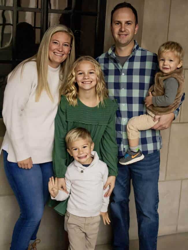 Matt Lundberg Family of five smiling together indoors, celebrating a special moment.