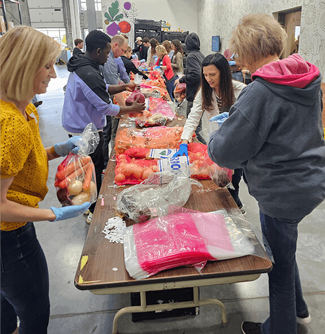 Volunteers pack food at the Food Bank of Lincoln during a community event.