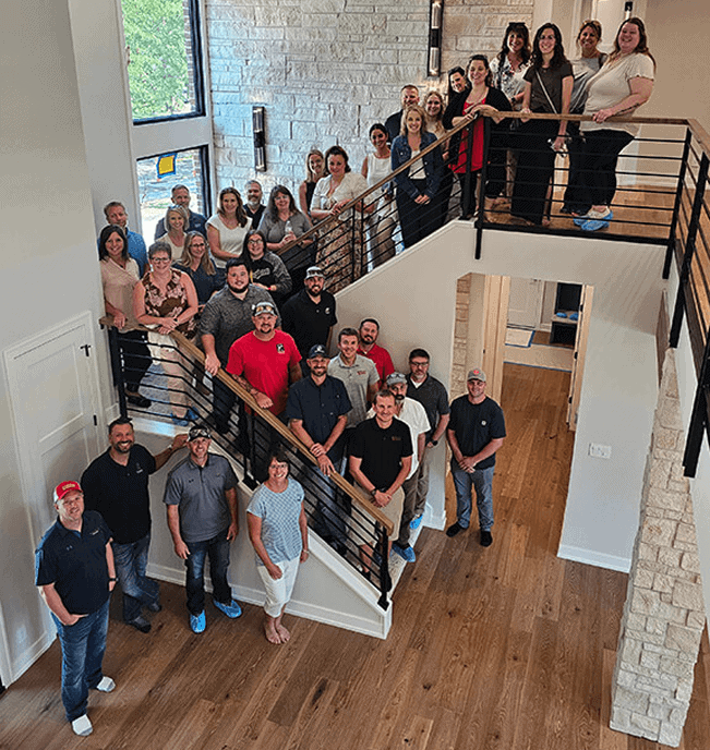 Group of people on staircase during a home renovation tour in Lincoln.