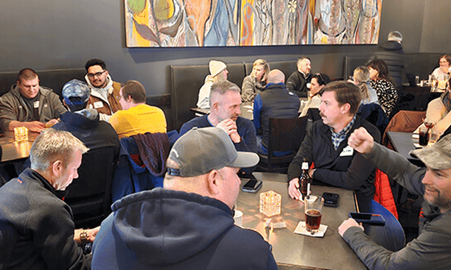 People socializing and playing games at a Remodelers Council Happy Hour event.