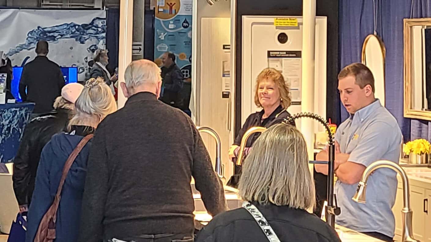 HomeShow-20220212_124745 People at a trade show viewing kitchen and bathroom fixtures.